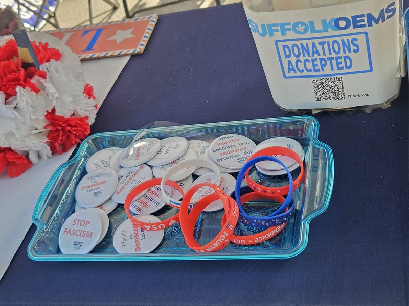 A tray of pin-on buttons, including ones that say "Stop Fascism", "Virginia is for Freedom lovers", and others